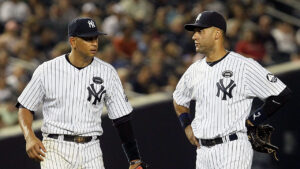 NEW YORK - JULY 16:  Derek Jeter #2 (R) and Alex Rodriguez #13 of the New York Yankees look on against the Tampa Bay Rays on July 16, 2010 at Yankee Stadium in the Bronx borough of New York City.  (Photo by Jim McIsaac/Getty Images)