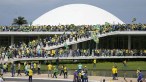 Protesters, supporters of Brazil's former President Jair Bolsonaro, storm the the National Congress building in Brasilia, Brazil, Sunday, Jan. 8, 2023. (AP Photo/Eraldo Peres)
