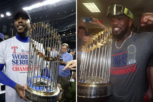 Dos cubanos con el trofeo de campeones de la Serie Mundial 2023.
