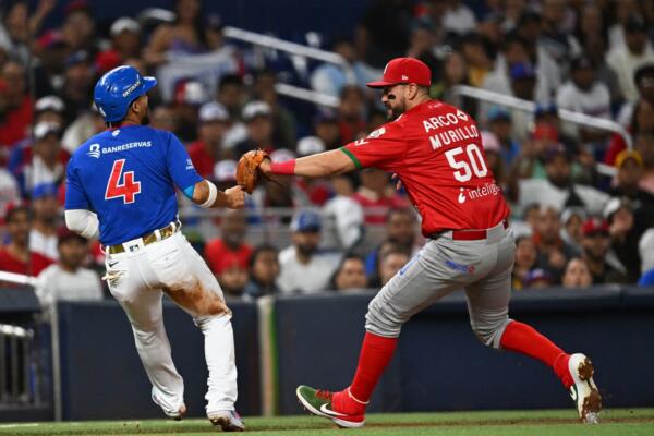 Mexico's infielder #50 Agustin Murillo Pineda tags out Dominican infielder #4 Gustavo Nunez at third base during the Caribbean Series baseball game between Mexico and the Dominican Republic at LoanDepot Park in Miami, Florida, on February 4, 2024. (Photo by Chandan Khanna / AFP)