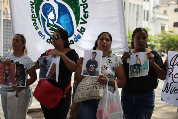 Familiares de adolescentes detenidos durante las protestas contra los resultados de elecciones presidenciales en Venezuela sostienen carteles este jueves, en una manifestación reclamando su libertad, en Caracas (Venezuela)