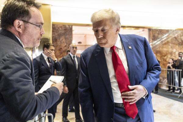 El expresidente de EE.UU., Donald J. Trump (d) atiende a un periodista en una conferencia de prensa en la Torre Trump en Nueva York