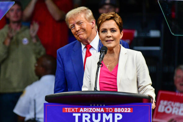Republican US Senate candidate Kari Lake (R) speaks alongside former US President and Republican presidential candidate Donald Trump during a campaign rally at Findlay Toyota Arena in Prescott Valley, Arizona, on October 13, 2024. (Photo by Caitlin O'Hara / AFP)