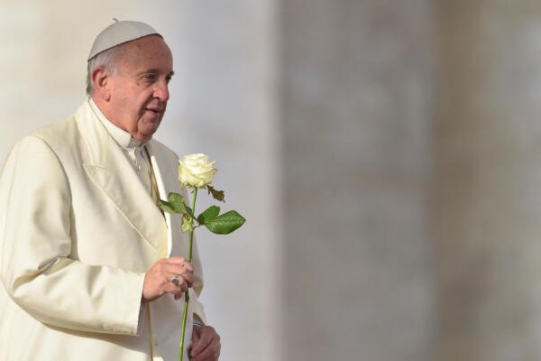 (FILES) Pope Francis brings a white rose to the Virgin Mary during his weekly general audience at St Peter's square on December 9, 2015 at the Vatican. Pope Francis 