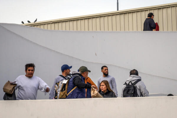 Migrantes deportados ayer, son vistos en el puerto fronterizo de El Chaparral, en Tijuana (México)