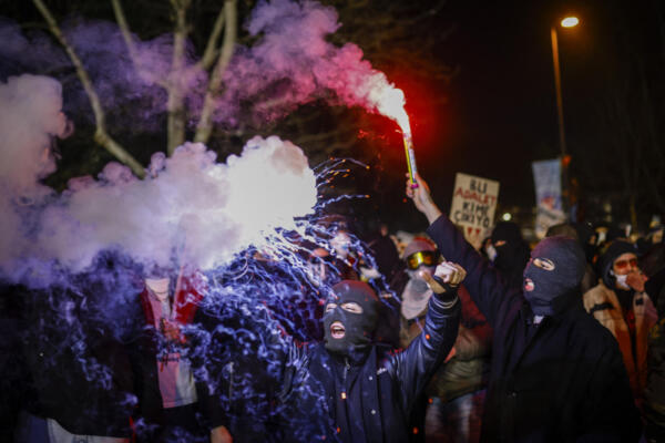 A protester holds a lit flare during a demonstration outside Istanbul's city hall to support Istanbul mayor Ekrem Imamoglu following his arrest in connection with two probes, one for 