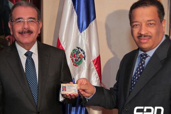 Foto de archivo del expresidente de la República, Danilo Medina, y el expresidente de la JCE, Roberto Rosario, en el momento en que le hacía entrega de la nueva cédula de identidad ano 20214. Foto: fuente externa.