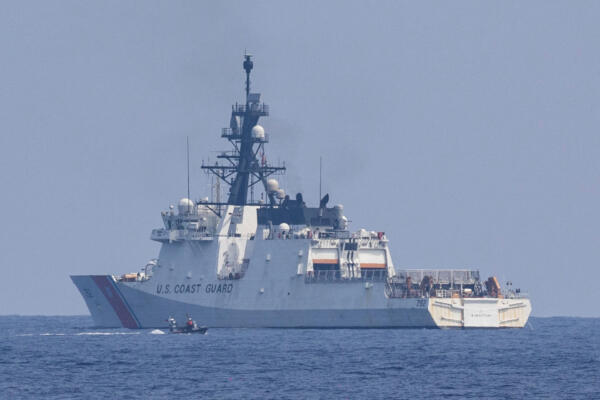 A Philippine Coast Guard boat passes by U.S. Coast Guard Cutter Stratton (WMSL 752) during drills in the first trilateral coast guard exercise between the Philippines, Japan, and the U.S., at the coast of Bataan, Philippines in the South China Sea, June 6, 2023. REUTERS/Eloisa Lopez