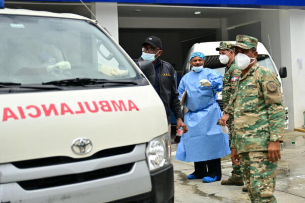 Un trabajador forense se encuentra en la entrada de la morgue del Instituto Nacional Forense mientras las ambulancias retiran los cuerpos de las víctimas tras el derrumbe del techo de la discoteca Jet Set en Santo Domingo el 11 de abril de 2025. (Foto de MARTIN BERNETTI / AFP)


