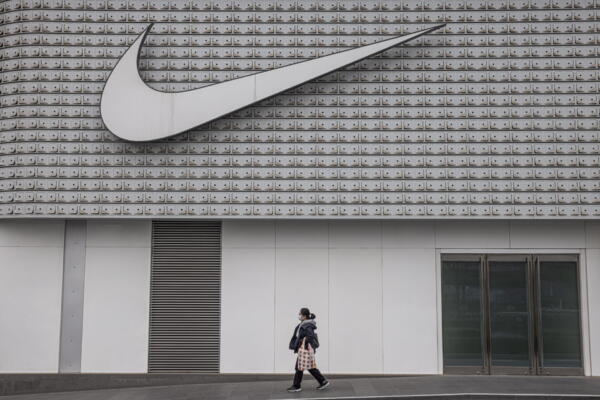 Fotografía muestra a una mujer pasando frente a una tienda Nike en Pekín, China. EFE/EPA/ROMAN PILIPEY