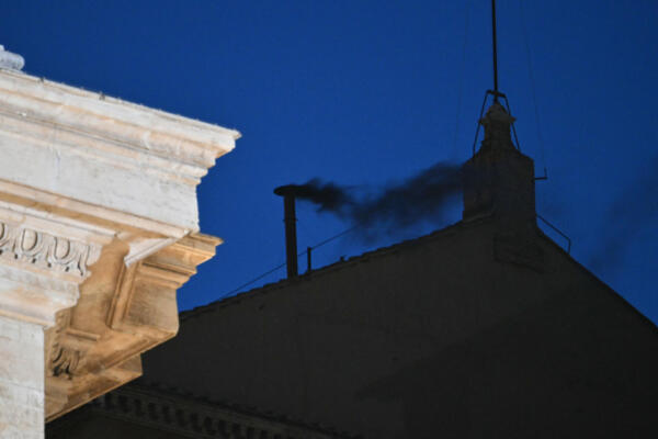 Esta fotografía muestra humo negro saliendo de la chimenea de la Capilla Sixtina, lo que indica que los cardenales no lograron elegir un nuevo papa en la primera votación de su cónclave en el Vaticano el 7 de mayo de 2025. (Foto de Alberto PIZZOLI / AFP)