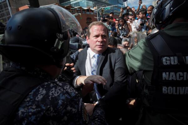 Fotografía de archivo, tomada el 7 de enero de 2020, del exdiputado opositor venezolano Juan Pablo Guanipa (c), al forcejear con efectivos de la Guardia Nacional Bolivariana (GNB), en Caracas (Venezuela). EFE/Rayner Peña