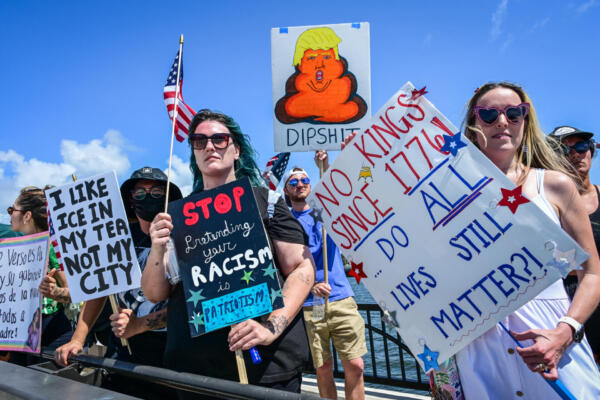 Demonstrators protest the Trump administration during the 