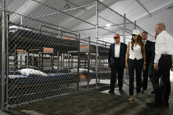 US President President Donald Trump (L), Florida Governor Ron DeSantis (2nd-R), and Secretary of Homeland Security Kristi Noem (2nd-L) tour a migrant detention center, dubbed 