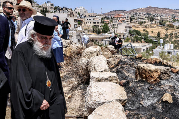 A Greek Orthodox clergyman walks at the fifth-century Church of St George in the Palestinian Christian village of Taybeh, northeast of Ramallah in the occupied West Bank on July 14, 2025, during a visit by the head clergymen of several Christian denominations days after an arson incident on the site reportedly by Israeli settlers. (Photo by Zain JAAFAR / AFP)