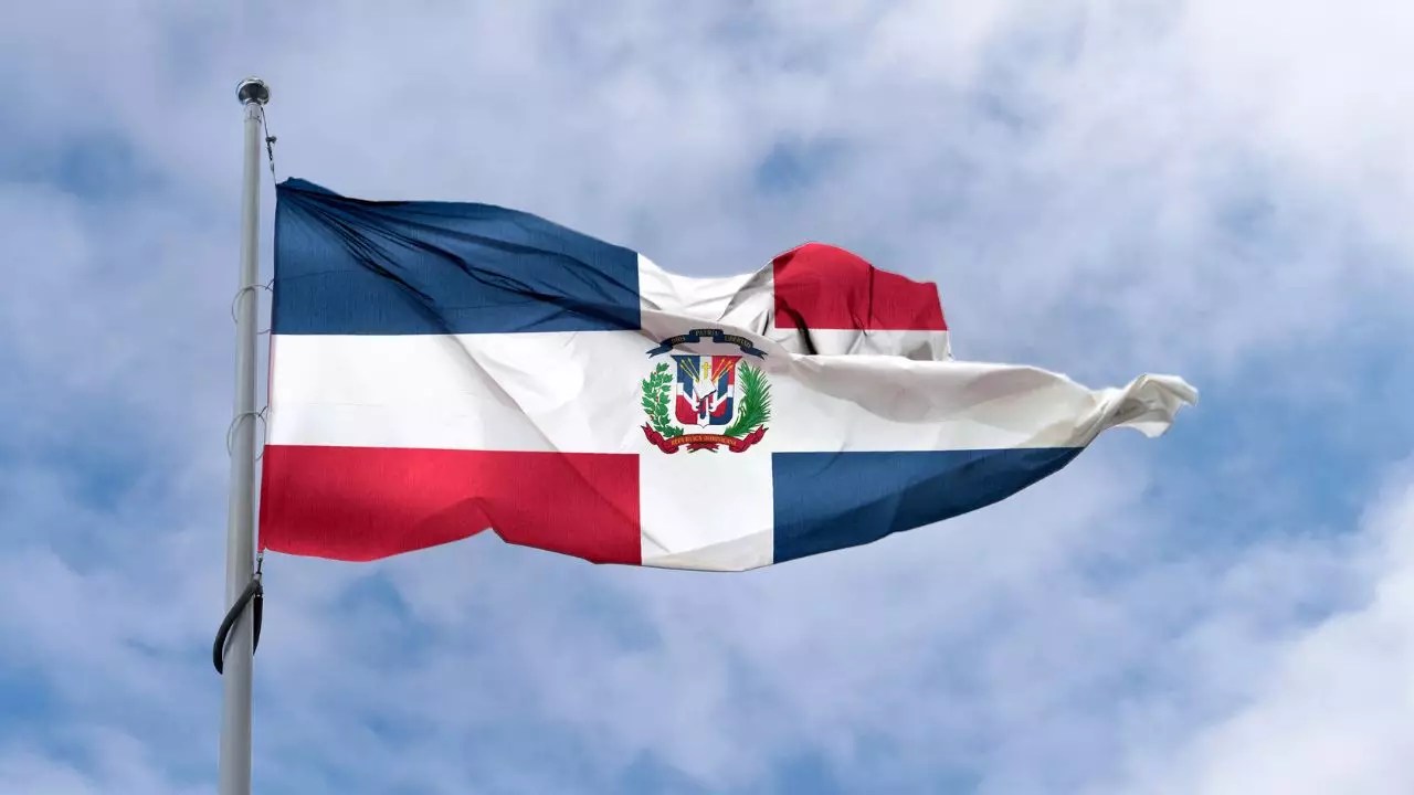 Bandera dominicana ondeando en acto oficial del Día de la Restauración