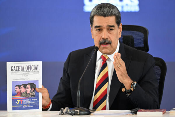 Venezuela's President Nicolas Maduro shows an official publication during a press conference in Caracas on September 1, 2025. Guyana's President Irfaan Ali, expressed on Monday his support for the deployment of US military forces in the Caribbean, while Caracas accused him of seeking to encourage a 'war front' due to allegations of a supposed attack from Venezuela against a Guyanese vessel. (Photo by JUAN BARRETO / AFP)