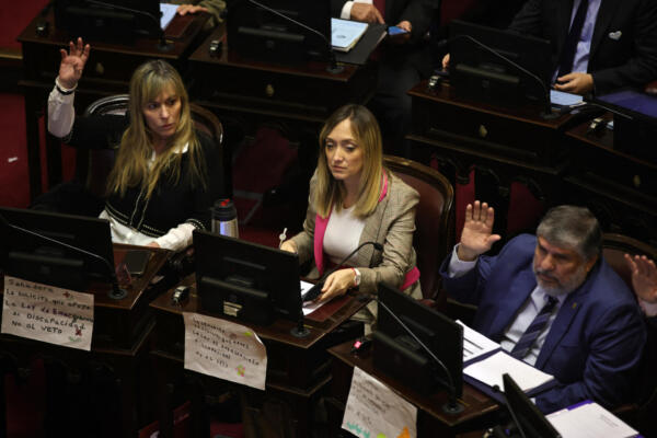 Opposition senators (L-R) Juliana Di Tulio, Anabel Sagasti and Jose Mayans attend a session as the Senate votes on whether to overturn a presidential veto on a law increasing pensions for the disabled, at the Congress in Buenos Aires on September 4, 2025. In August, the Congress overruled President Javier Milei's veto on a law declaring a disability emergency and allocating more funds to the sector -- a major political blow to the president and his budget-slashing approach. (Photo by Emiliano Lasalvia / AFP)