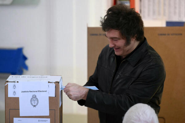 Argentina's President Javier Milei casts his vote at a polling station during the national midterm legislative elections in Buenos Aires on October 26, 2025. Argentines head to the polls for a midterm election that will determine whether President Javier Milei enters the second half of his term bolstered or diminished as economic troubles abound despite unprecedented US aid. (Photo by Luis ROBAYO / AFP)