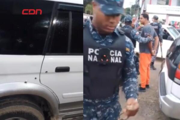Agentes policiales inspeccionan la yipeta impactada por varios disparos tras el ataque armado ocurrido en el sector Monterico, en Santiago Oeste.