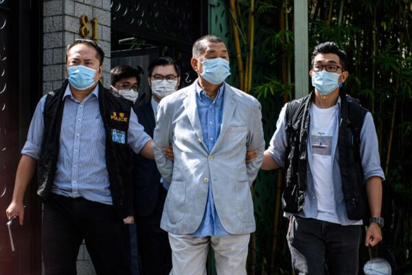 La policía saca de su domicilio al magnate de los medios prodemocracia de Hong Kong, Jimmy Lai (C), tras ser arrestado bajo la nueva ley de seguridad nacional en Hong Kong el 10 de agosto de 2020. El 9 de febrero de 2026, un tribunal de Hong Kong condenó a Jimmy Lai a 20 años de prisión tras su sonado juicio por violación de la ley de seguridad nacional, que organizaciones de derechos humanos y países occidentales han condenado como un símbolo del debilitamiento de la libertad de prensa en la ciudad. (Foto de VERNON YUEN / AFP)