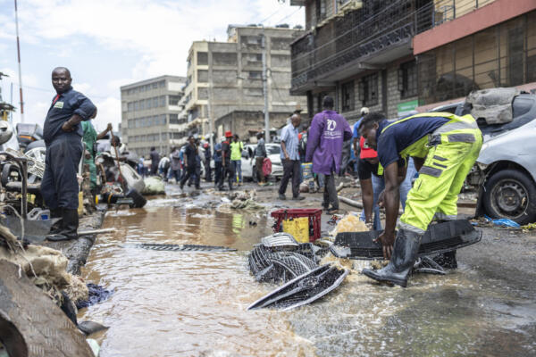 Personas rescatan sus propiedades de las inundaciones en el centro de Nairobi, tras una noche de fuertes lluvias que provocaron graves inundaciones en la zona el 7 de marzo de 2026. (Foto de Tony Karumba / AFP)
