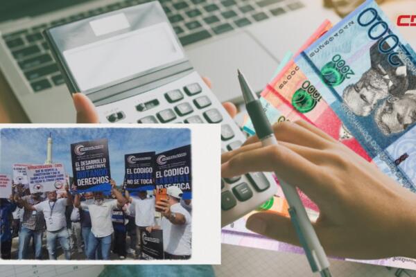 Miembros de la CNUS marcharon en Santiago con pancartas y consignas en defensa de la cesantía laboral previo al 1 de mayo.
