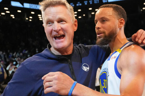 Steve Kerr, dirigente de Golden State, abraza a su estrellas Steven Curry