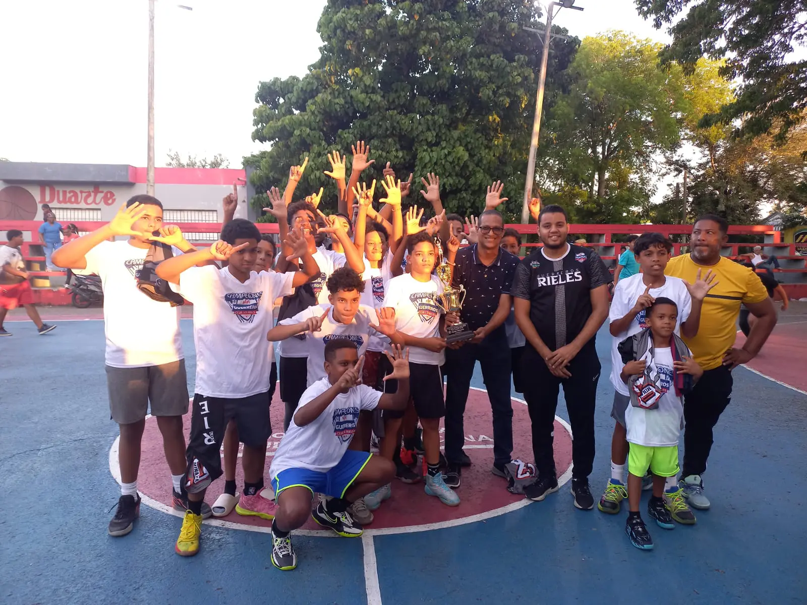 Virgilio Vásquez directivo de Abaprodu entrega la cipa Alex Díaz alcalde a los jugadores y directivos del club Guerrero de los Rieles nuevos campeones del basket U14 francomacorisano.