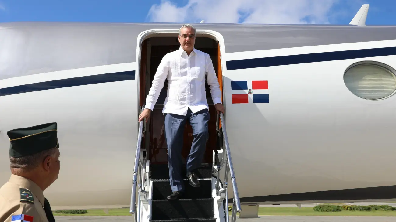 Santo Domingo.- El presidente Luis Abinader regresó al país pasadas las 3:15 de la tarde de este viernes por el Aeropuerto Internacional de Punta Cana, tras su viaje a Washington D. C., donde participó en la Cumbre Ejecutiva de la Asociación Americana de Prendas de Vestir y Calzado (AAFA). A su llegada al país, el jefe de Estado fue recibido por el ministro de Defensa, teniente general Carlos Antonio Fernández Onofre, y el director del Instituto Dominicano de Aviación Civil (IDAC), Igor David Rodríguez Durán. Promueve a RD como destino ideal para la inversión industrial textil y de calzado Durante su participación en la conferencia “Cadena de suministro y comercio global” de la Asociación Americana de Prendas de Vestir y Calzado, el mandatario resaltó que la República Dominicana es un destino ideal para aquellos que buscan infraestructura y una fuerza laboral confiable más cercana a uno de los mercados de consumo más dinámicos del mundo. El presidente Abinader destacó que, además de una plataforma industrial y logística que marca el ritmo en América Latina y el Caribe, la República Dominicana ofrece políticas favorables al mercado, transparencia y estabilidad, lo que la convierten en un socio ideal para cualquier empresa estadounidense que trace un camino hacia un crecimiento sostenible. Además, el jefe de Estado sostuvo una reunión de coordinación con empresarios dominicanos tras su arribo el miércoles a Washington. Los empresarios, que acompañaron al mandatario en el encuentro fueron Samuel Conde, Claudia Pellerano, Aquiles Bermúdez, Steven Puig, Fernando Capellán, Alejandro Marranzini, Joe Torres, José Manuel Santelises, Ricardo Pérez Joseph Blumberg, Alejandro Peña Prieto y Pepe Fanjul. También participó el ministro de Industria, Comercio y Mipymes, Víctor Bisonó. Visita la Universidad Purdue en Indiana Antes de su regreso al país, el mandatario realizó una visita a la Universidad de Purdue en el Estado de Indiana, en preparación para un acuerdo de cooperación, en procura de que en el futuro la República Dominicana esté en capacidad de producir semiconductores para exportar a los Estados Unidos. La Universidad Purdue es la principal productora de chips y suple a todos los Estados Unidos. De lograrse esto, la República Dominicana podría estar a la vanguardia con la instalación de empresas productoras de semiconductores y con la producción de estos en muy poco tiempo. La visita realizada por el presidente Abinader, quien fue invitado por las autoridades de Purdue, apunta a la formalización en el futuro cercano de un acuerdo, en pocas semanas, entre dicha universidad y el país. La reducida comitiva que acompañó al presidente estuvo compuesta por sus asistentes Eilyn Beltrán, director del Gabinete Presidencial; Mercedes Pichardo; el director del Cusep y jefe de la seguridad del presidente, Jimmy Arias, así como el director de prensa del Presidente, Daniel García Archibald.