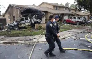 Police officers search the site where a small plane crashed on a San Diego, California, residential street on May 22, 2025. The Federal Aviation Authority said a Cessna 550 crashed at around 3:45 am local time. The neighborhood is close to the Montgomery-Gibbs Executive Airport. The crash left a 