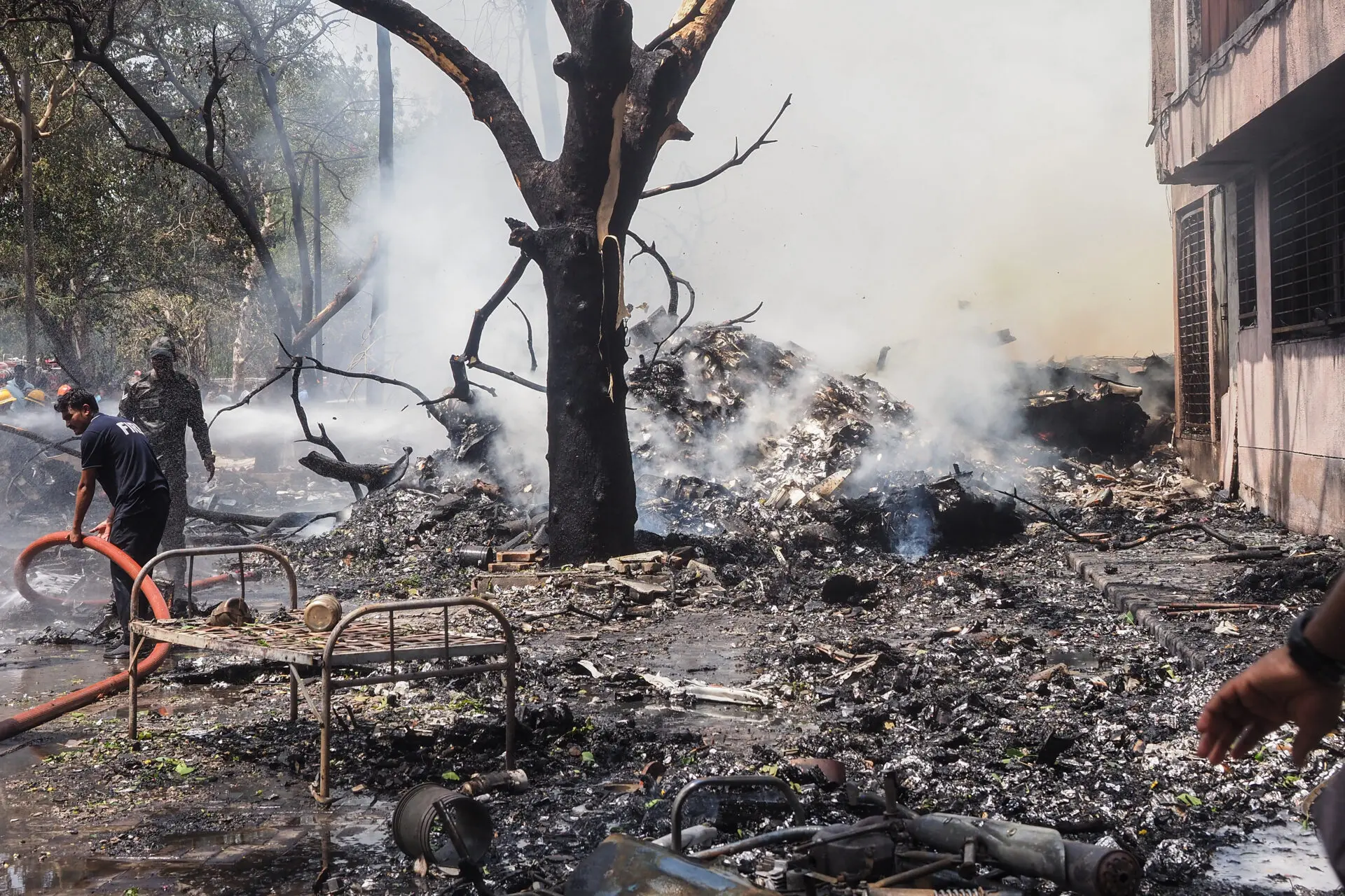 Firefighters work at the site where Air India flight 171 crashed in a residential area near the airport in Ahmedabad on June 12, 2025. The London-bound passenger plane crashed on June 12 in India's western city of Ahmedabad with 242 on board, aviation officials said in what the airline called a "tragic accident". (Photo by Sam PANTHAKY / AFP)