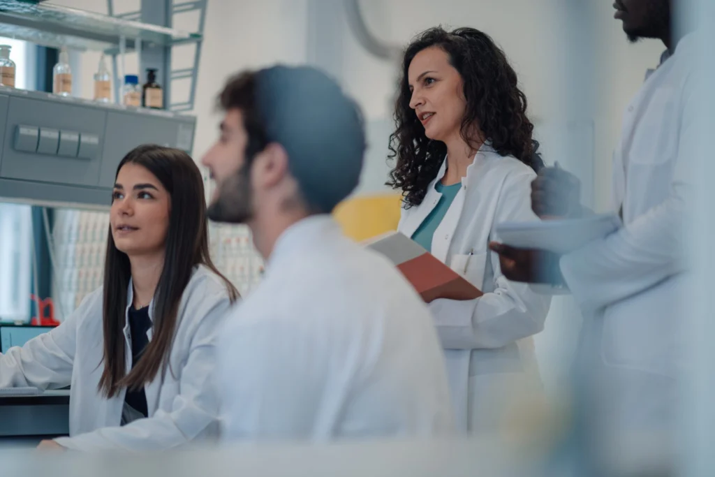 Research,Team,Of,Students,And,Professors,Working,Together,In,A